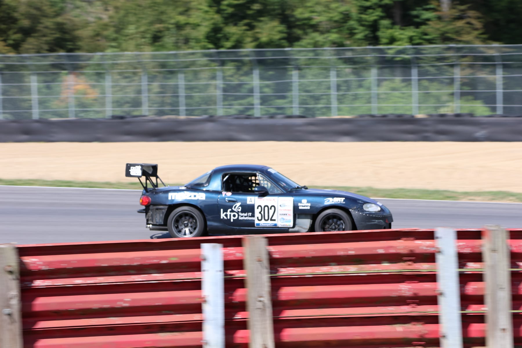 Senhauser Racing #302 Mazda Miata mid-corner at Mid-Ohio
